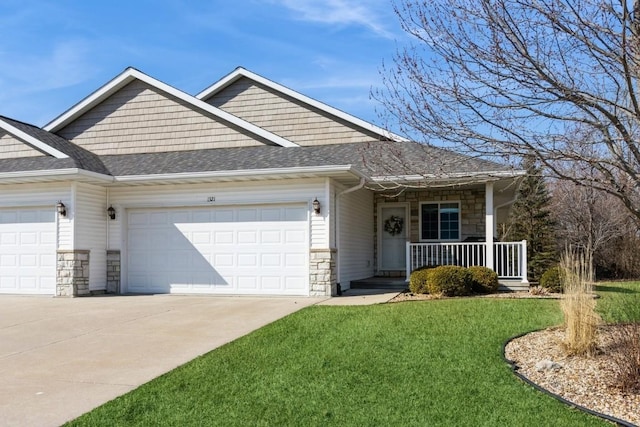 view of front facade with a front lawn, a porch, driveway, stone siding, and an attached garage