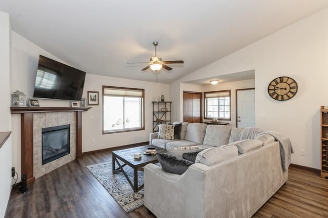 living area with vaulted ceiling, dark wood-type flooring, a wealth of natural light, and ceiling fan