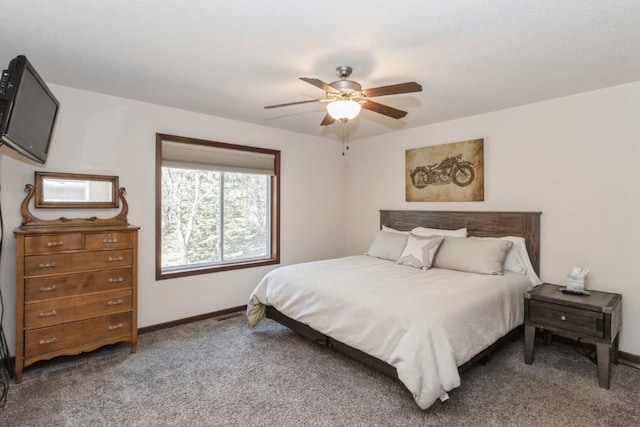 carpeted bedroom with ceiling fan and baseboards