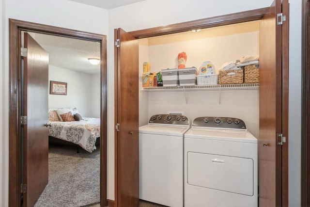 washroom featuring laundry area, a textured ceiling, carpet floors, and separate washer and dryer