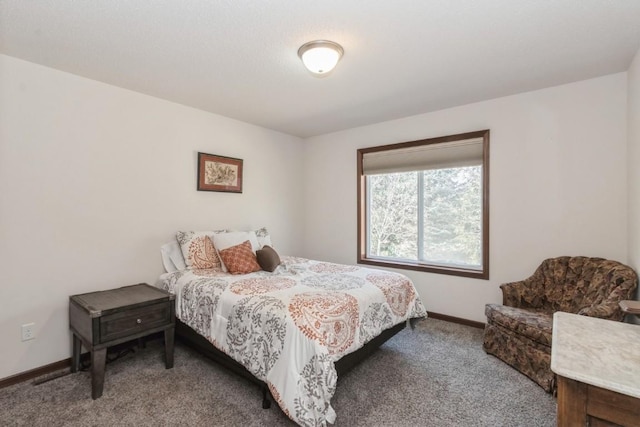 carpeted bedroom featuring baseboards