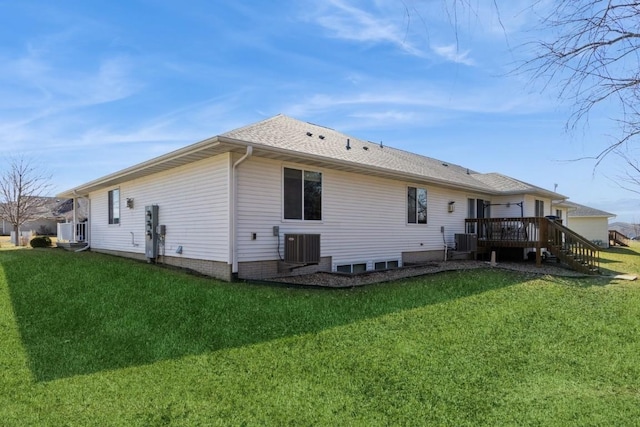 rear view of property featuring a yard, a deck, and cooling unit