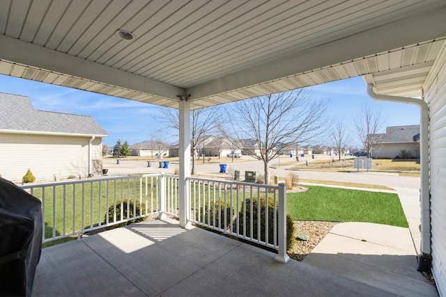 view of patio with a residential view, covered porch, and a grill