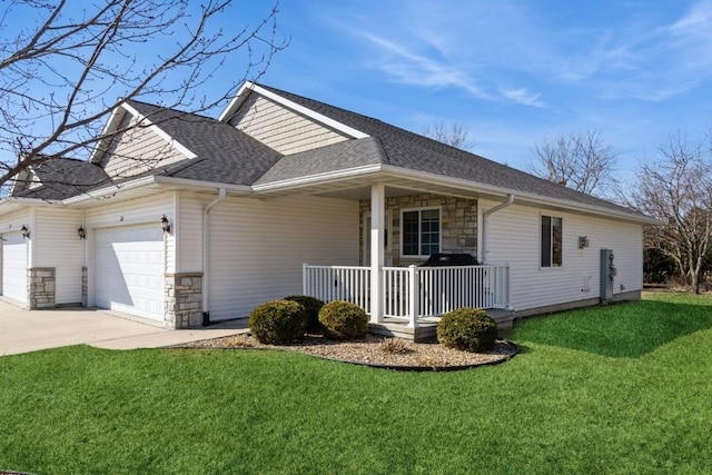 view of home's exterior featuring a porch, a yard, a garage, and stone siding