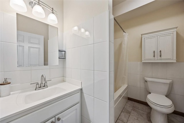 full bath with vanity, toilet, tile walls, and shower / bath combo