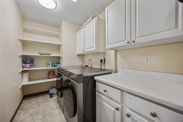 laundry room with baseboards, cabinet space, and washing machine and clothes dryer