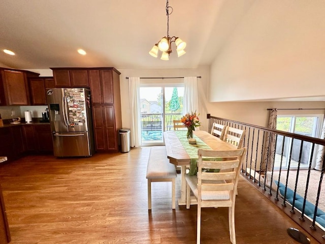 dining area featuring recessed lighting, light wood-type flooring, and a notable chandelier