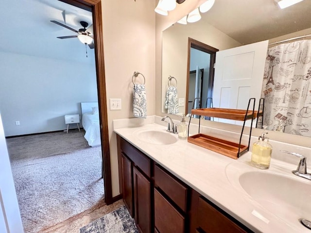 bathroom with a sink, connected bathroom, a ceiling fan, and double vanity