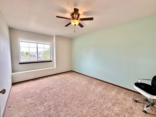 empty room with baseboards, ceiling fan, and carpet floors