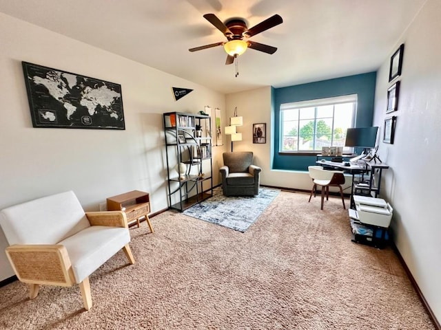 sitting room with carpet flooring, a ceiling fan, and baseboards