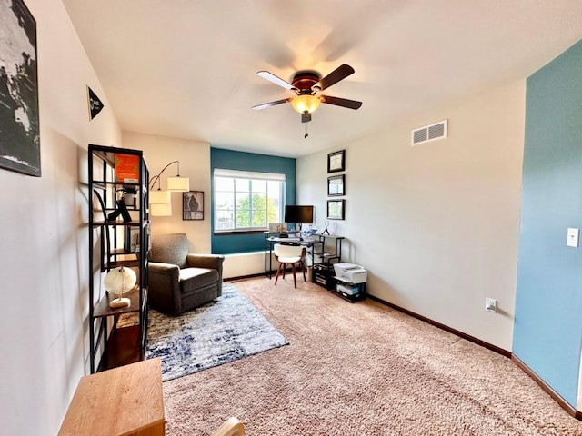 home office featuring a ceiling fan, visible vents, carpet floors, and baseboards