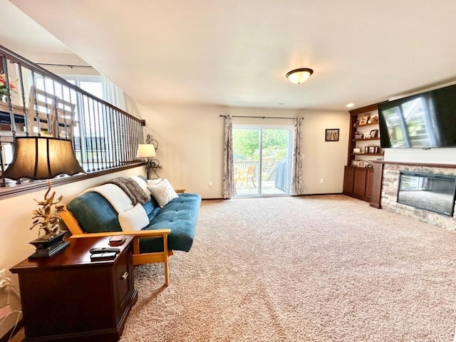 living room featuring a stone fireplace, built in features, baseboards, and carpet floors