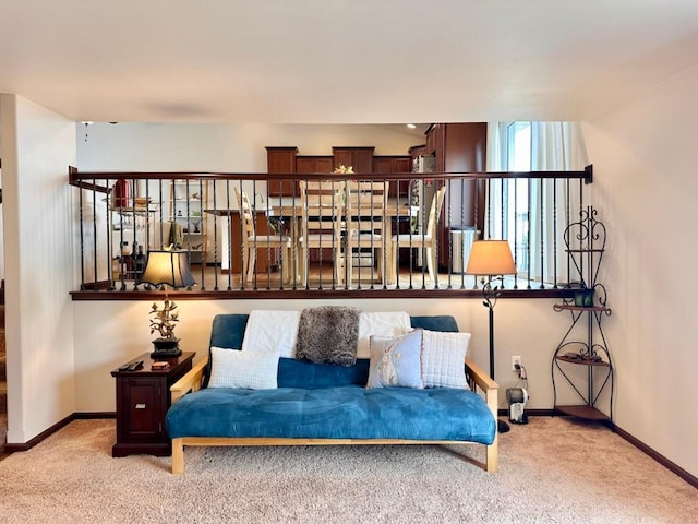 carpeted living room featuring baseboards