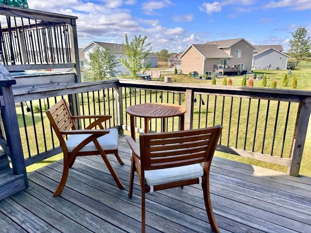 deck featuring a residential view and a lawn