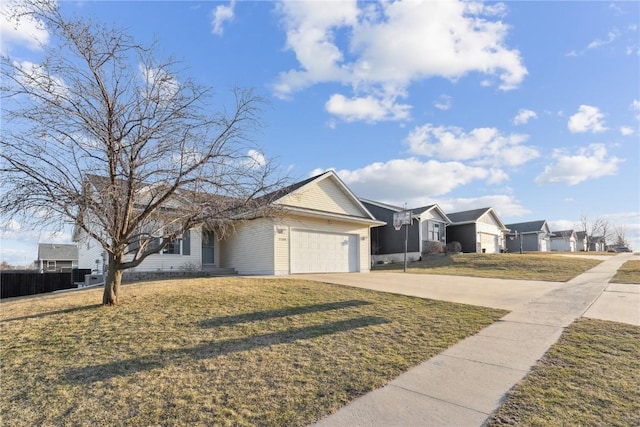 view of front of house featuring a garage, concrete driveway, and a front lawn