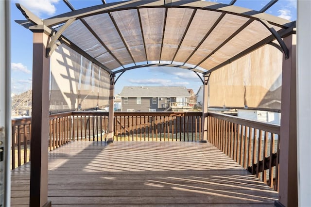 wooden terrace with a residential view and a pergola