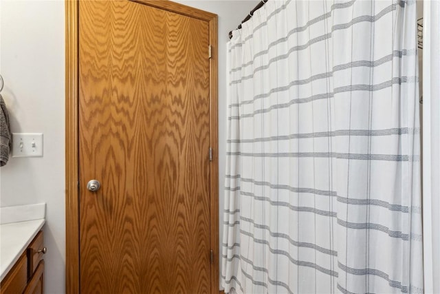 bathroom featuring curtained shower and vanity