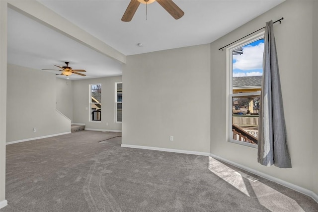 unfurnished room featuring a healthy amount of sunlight, a ceiling fan, and carpet floors