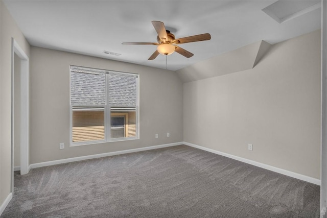 unfurnished room with attic access, baseboards, a ceiling fan, and carpet floors