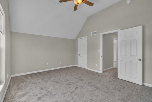 unfurnished bedroom featuring visible vents, a ceiling fan, baseboards, carpet flooring, and lofted ceiling