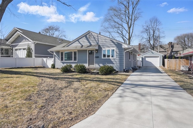 view of front of house with fence, an outdoor structure, a front yard, concrete driveway, and a garage