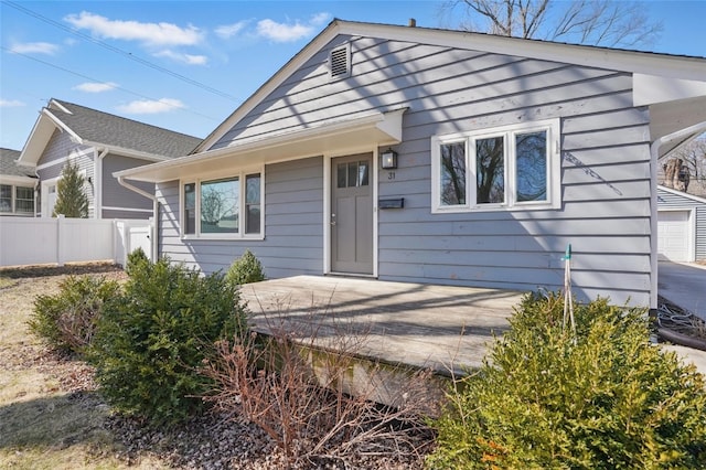 view of front of home featuring fence