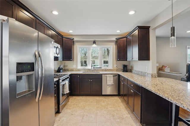 kitchen featuring light stone countertops, recessed lighting, a sink, stainless steel appliances, and dark brown cabinetry