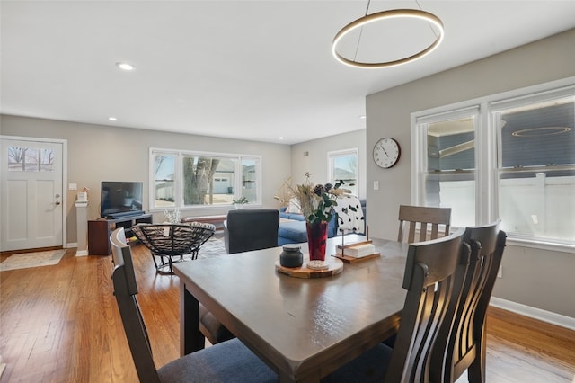 dining room with recessed lighting, light wood-type flooring, and baseboards