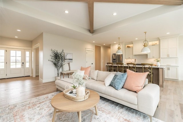 living area with recessed lighting, light wood-type flooring, and baseboards