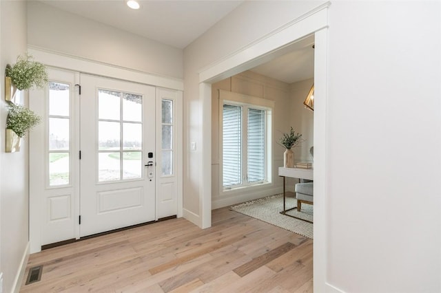 foyer featuring recessed lighting, visible vents, plenty of natural light, and light wood-type flooring