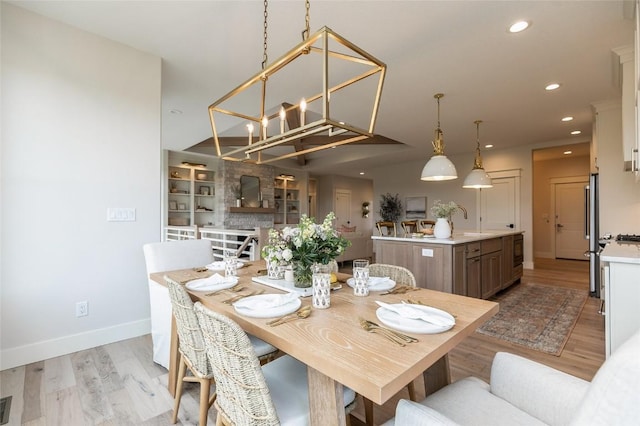 dining space with light wood-style flooring, recessed lighting, and baseboards