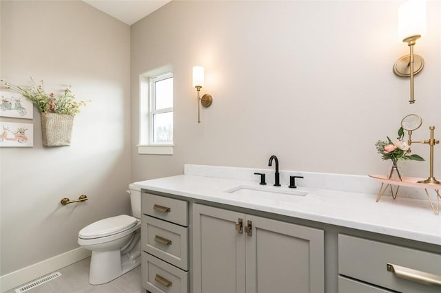 bathroom featuring tile patterned floors, visible vents, toilet, baseboards, and vanity