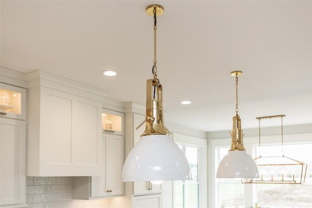 details featuring recessed lighting, glass insert cabinets, pendant lighting, and white cabinets