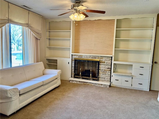 unfurnished living room with a textured ceiling, visible vents, carpet floors, and ceiling fan