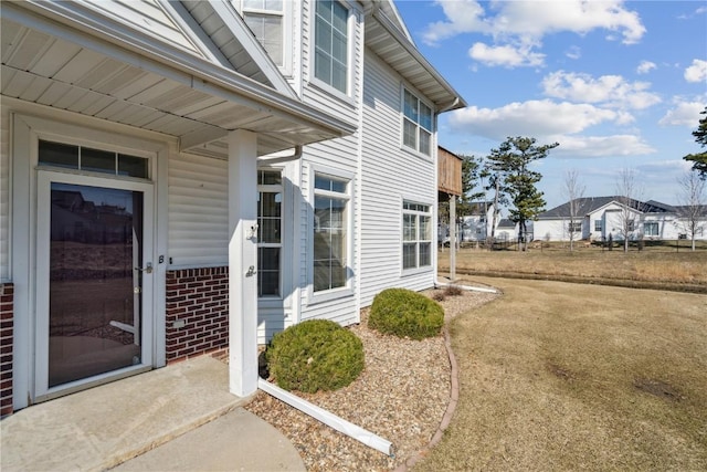 doorway to property featuring brick siding