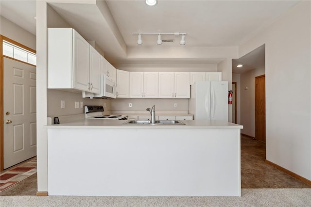 kitchen with carpet floors, a peninsula, white appliances, white cabinetry, and a sink