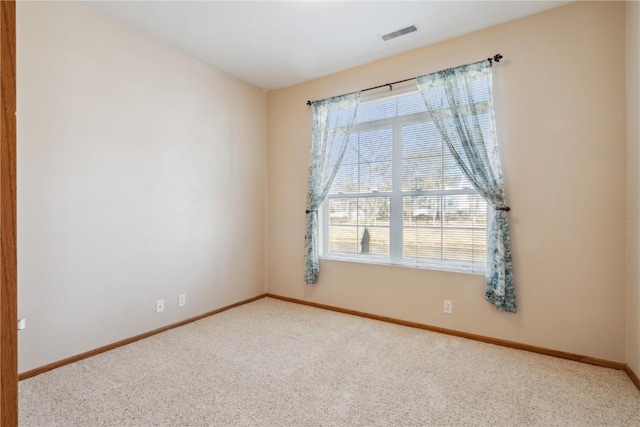 unfurnished room featuring visible vents, carpet floors, and baseboards