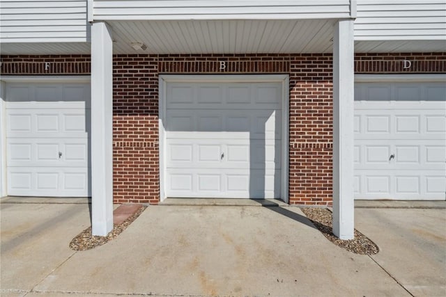 exterior space with brick siding and community garages