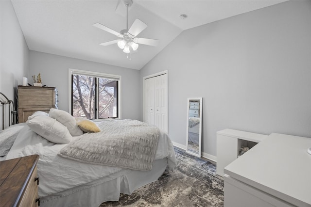 bedroom featuring lofted ceiling, baseboards, a closet, and ceiling fan