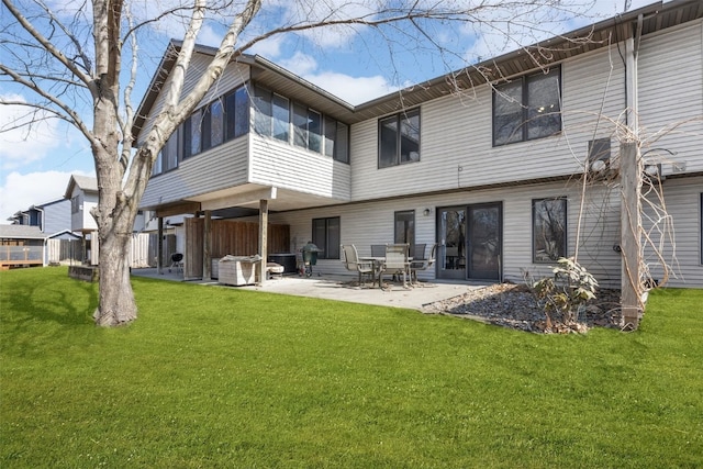 back of property featuring a lawn and a patio area