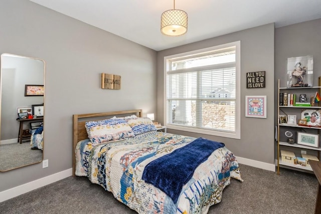 bedroom featuring baseboards and dark colored carpet