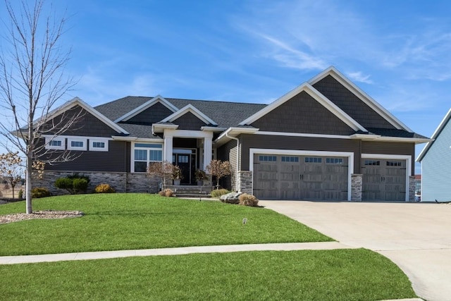 craftsman house with stone siding, an attached garage, concrete driveway, and a front lawn