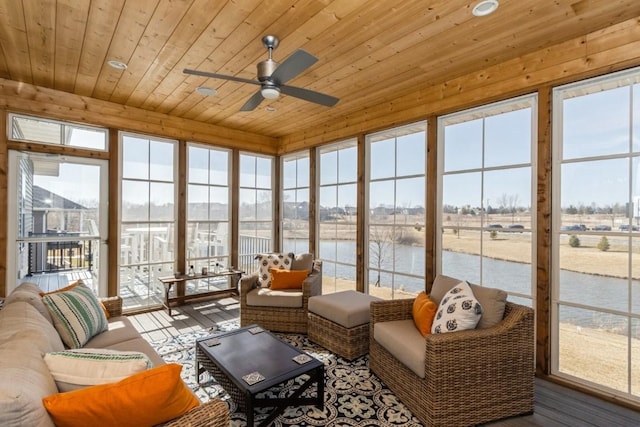 sunroom / solarium with wooden ceiling, a ceiling fan, and a water view