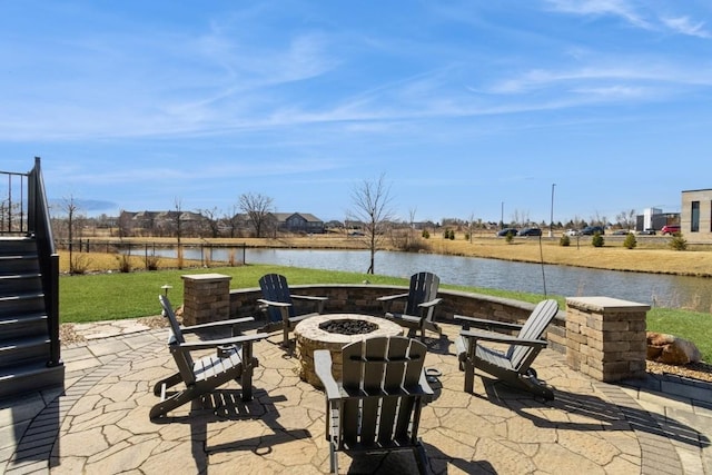 view of patio / terrace with a water view and a fire pit