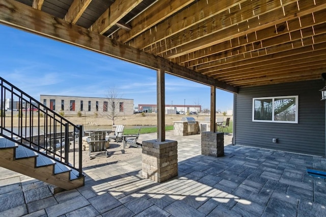 view of patio / terrace with area for grilling and stairway