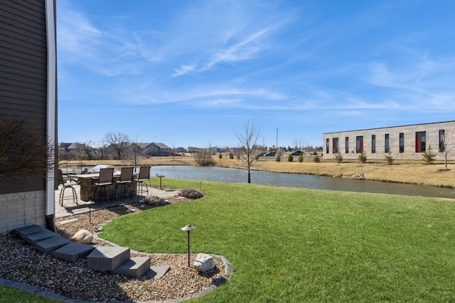 view of yard with a patio and a water view