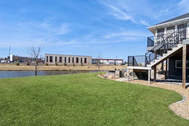 view of yard featuring stairway and a water view