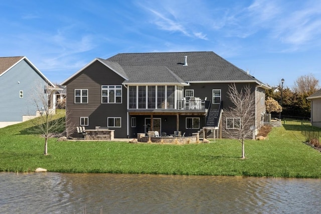 rear view of property with a patio area, stairway, a yard, and a sunroom