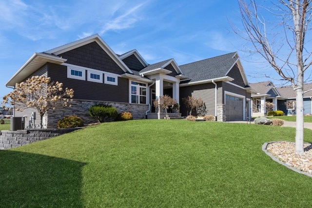 view of front of home with a front yard, an attached garage, and stone siding