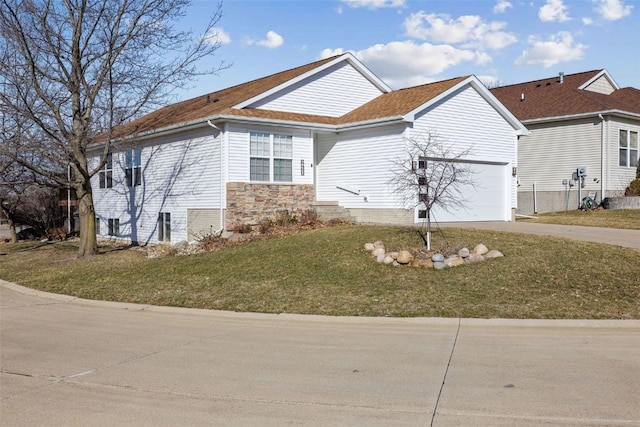 view of property exterior featuring stone siding, driveway, and a yard